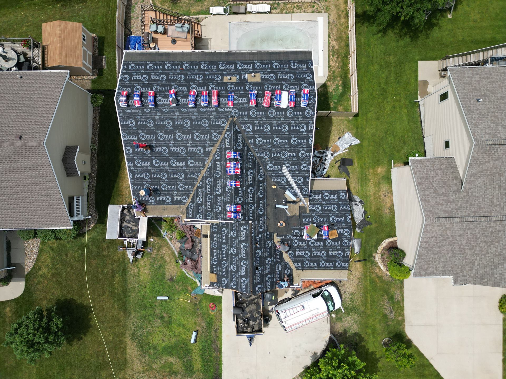 An aerial view of a house with a roof being installed.