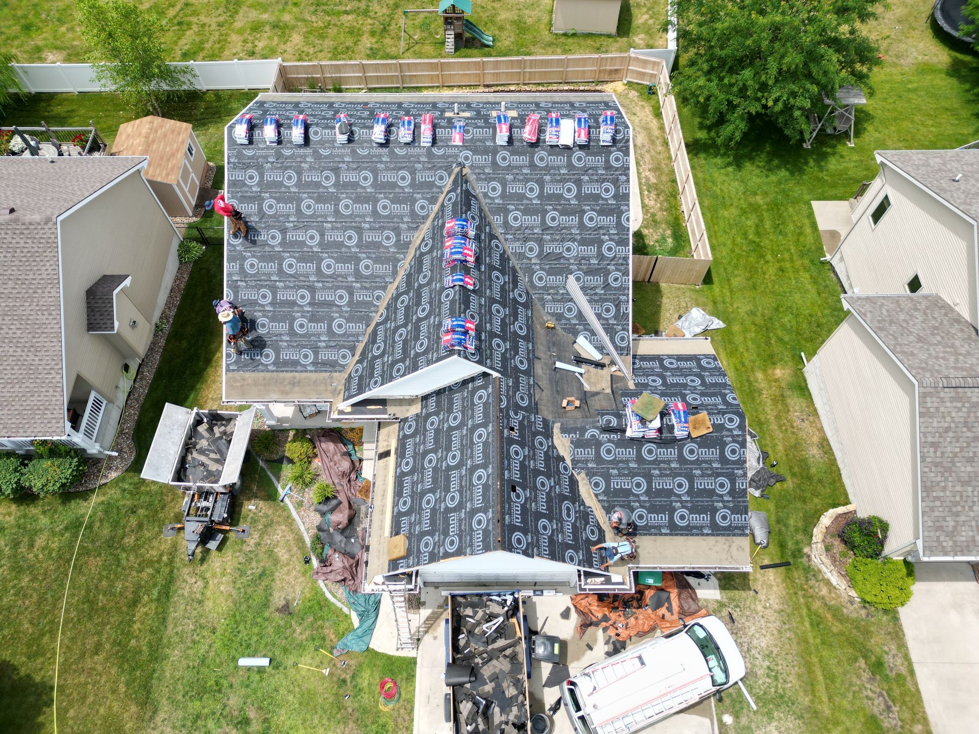 An aerial view of a roof being installed on a house.