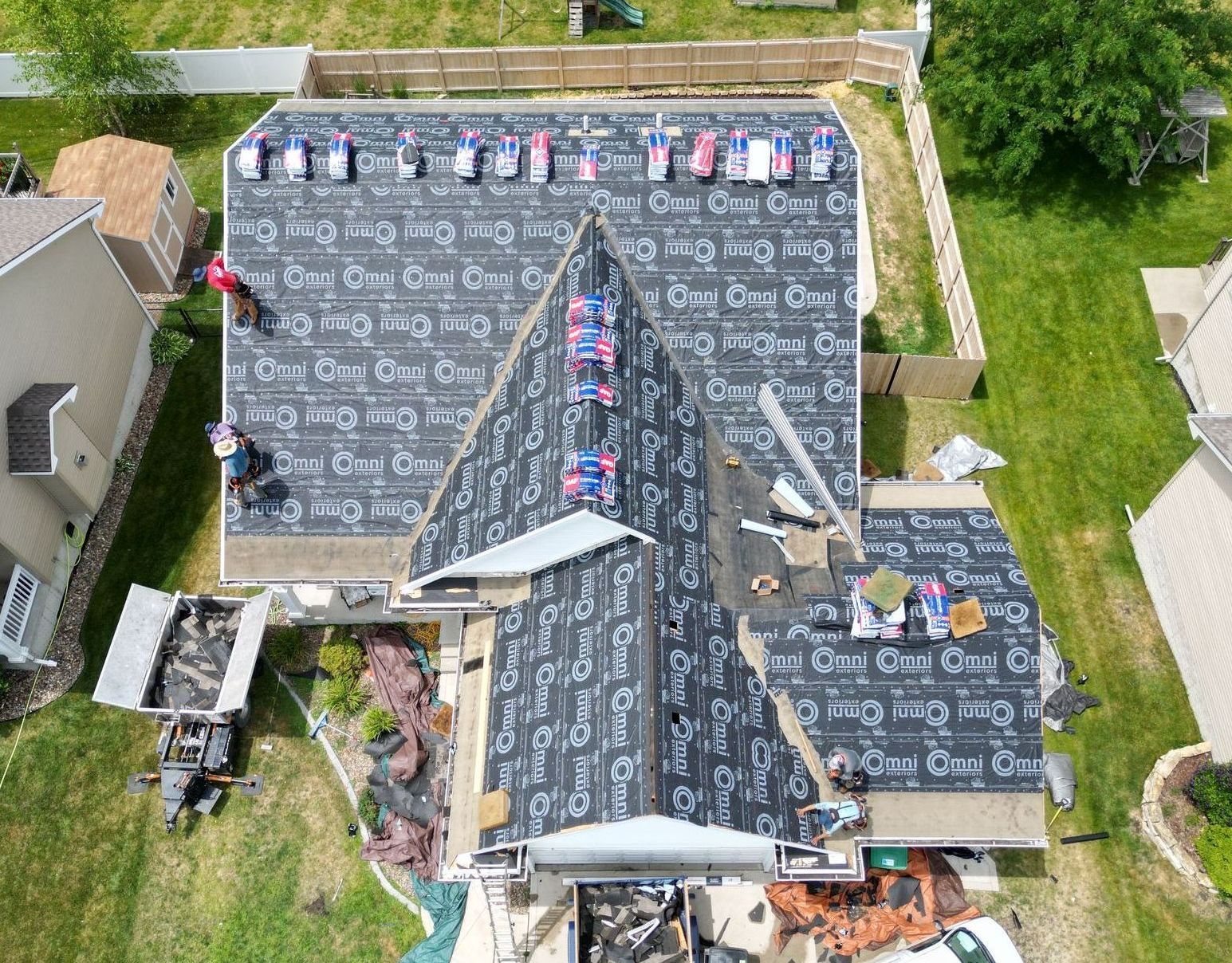 An aerial view of a roof being installed on a house.