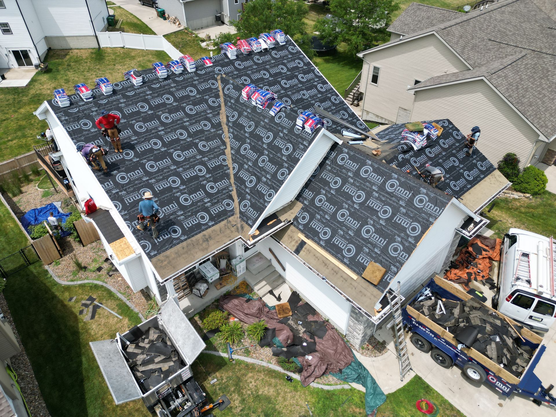 An aerial view of a roof being installed on a house.