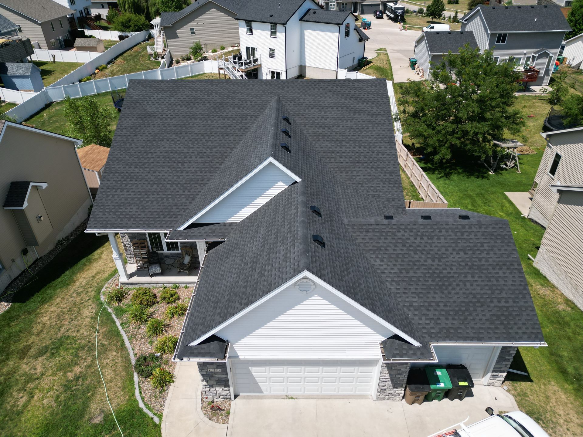 An aerial view of a house with a new roof.