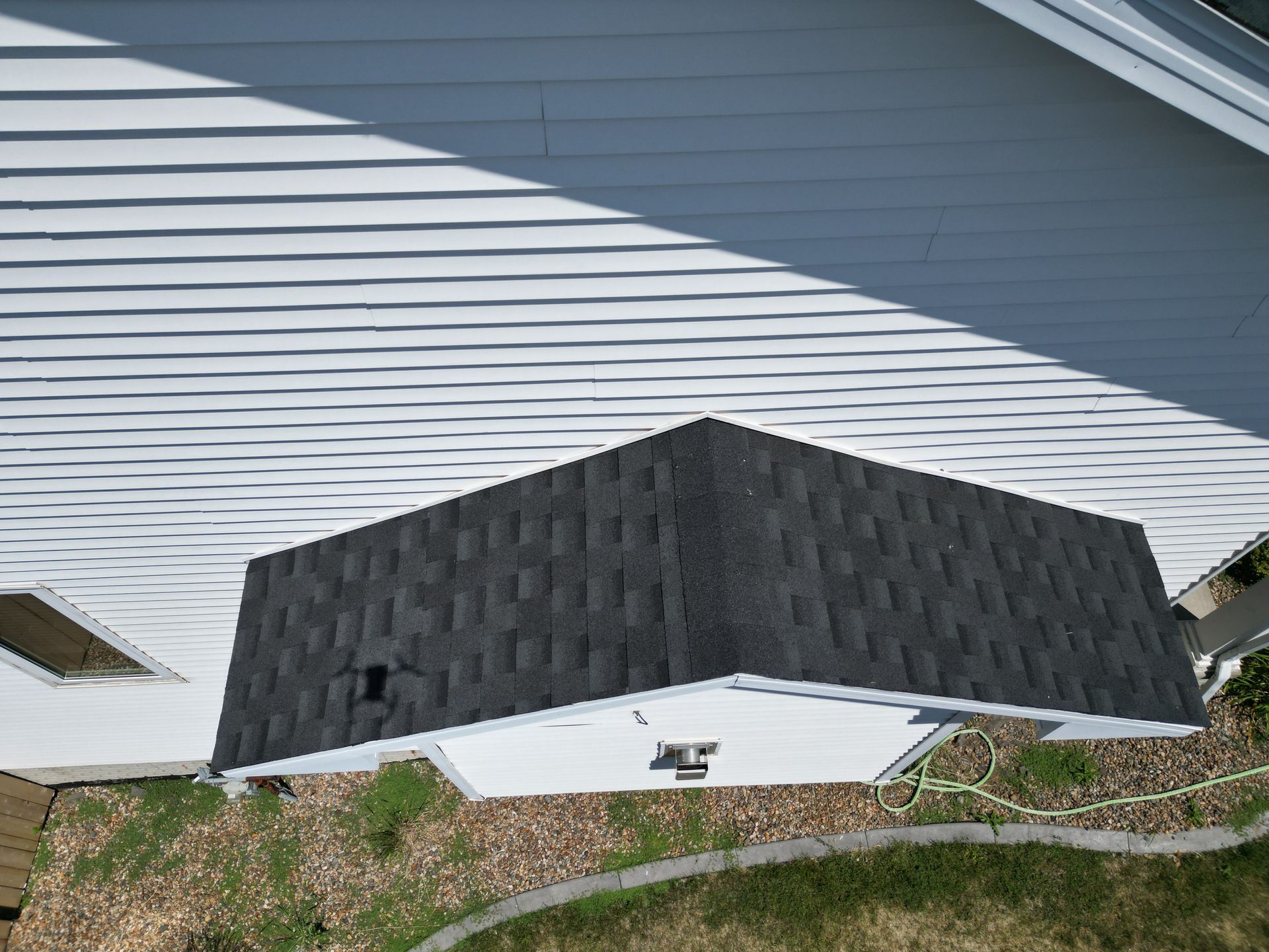 An aerial view of a house with a black roof