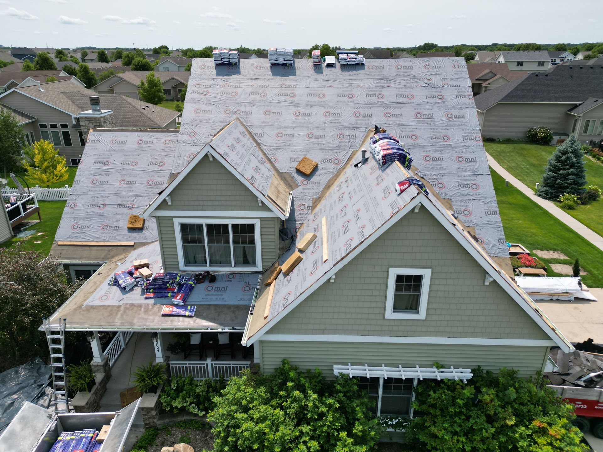 An aerial view of a house being remodeled with a new roof.