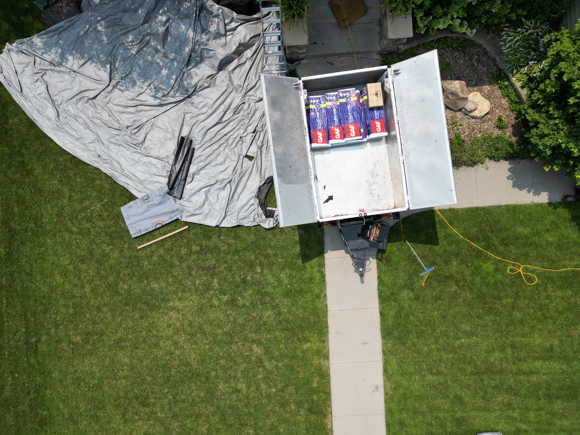 An aerial view of a truck sitting on top of a lush green lawn.