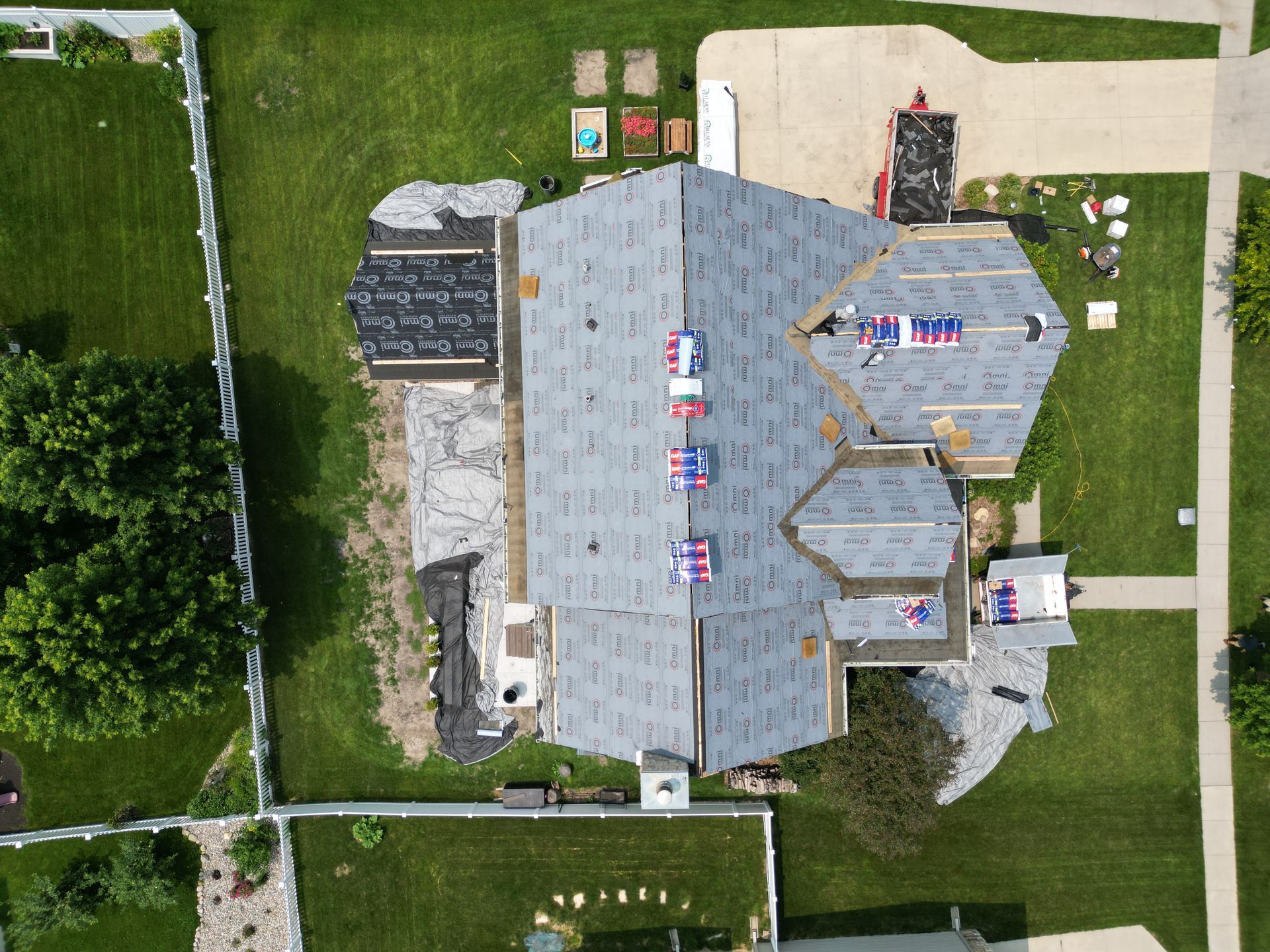 An aerial view of a house with a roof being installed