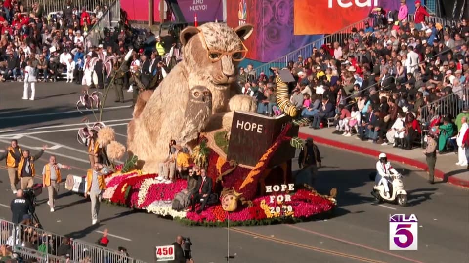 A parade with a float that says hope on it