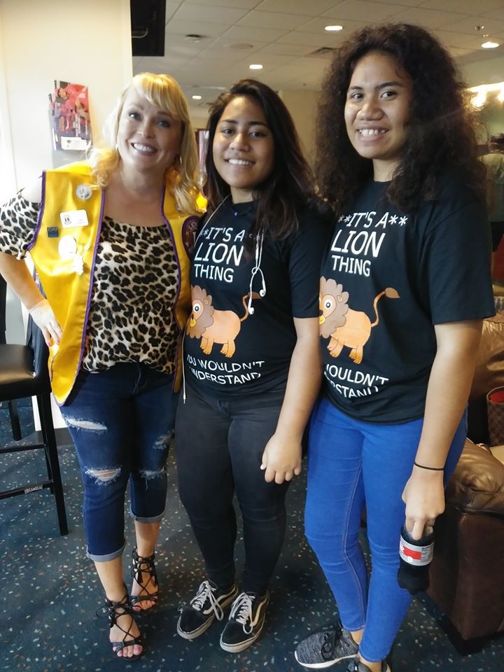 Three women wearing shirts that say it 's a lion thing