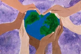 A group of people are holding the earth in their hands in the shape of a heart.