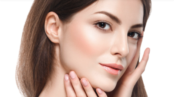 A close up of a woman 's face with her hand on her chin.