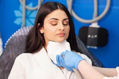 A woman is getting a facial treatment at a beauty salon.