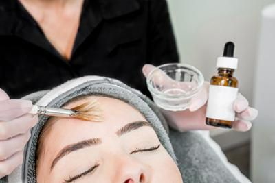 A woman is getting a facial treatment at a beauty salon.