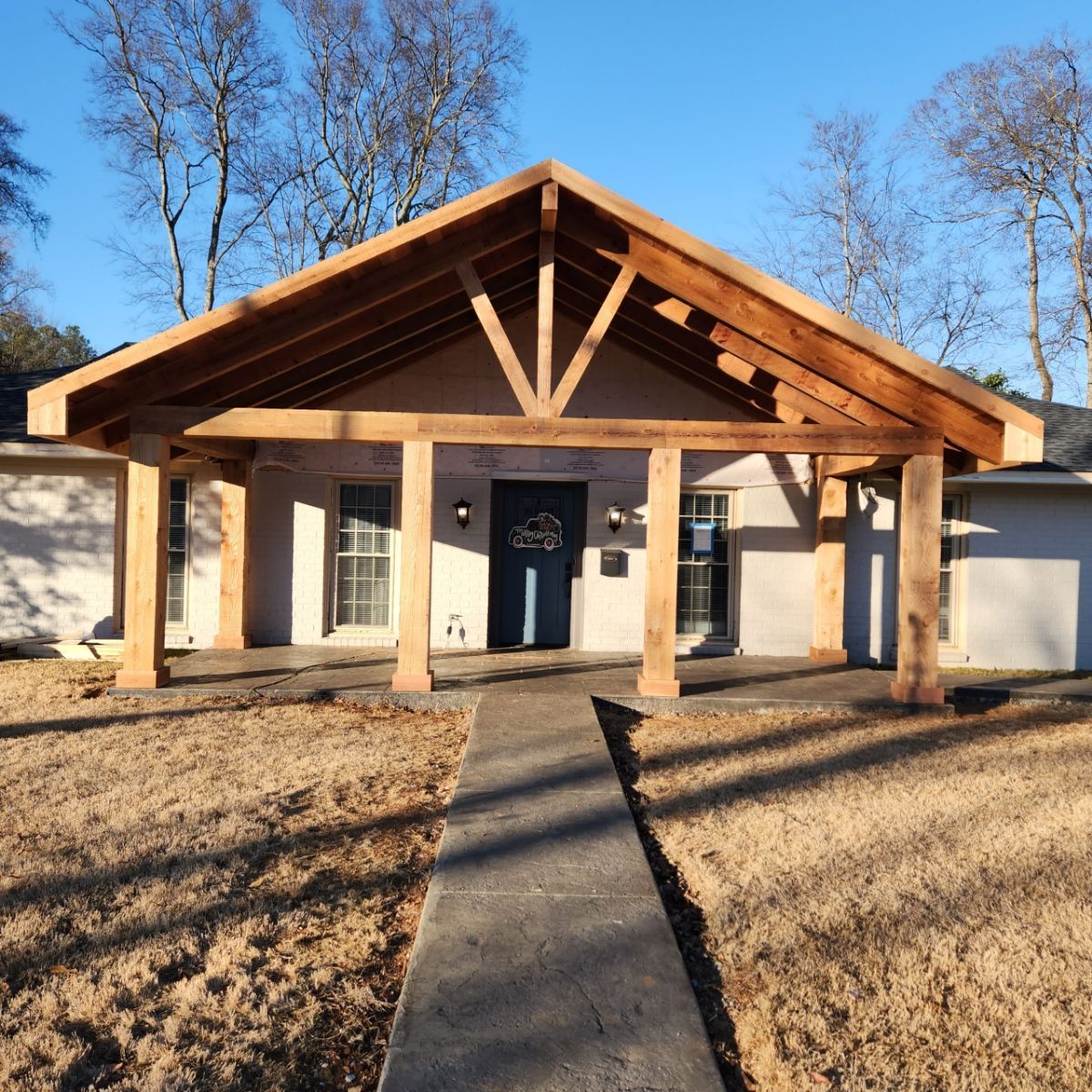A house with a wooden porch and a walkway leading to it