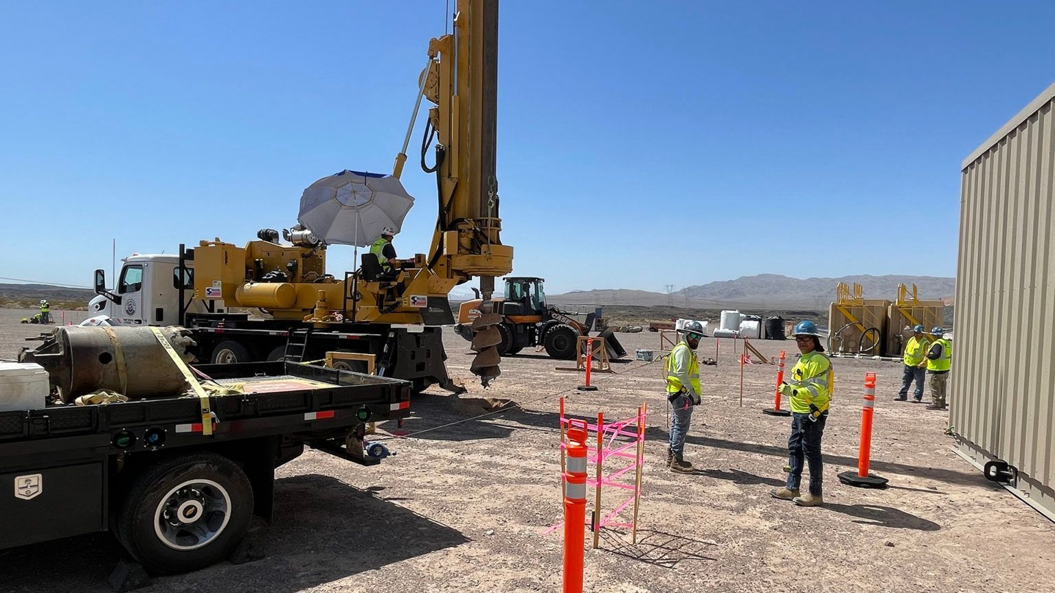 Construction Personnel Perform Concrete Pier Excavations for E-house
