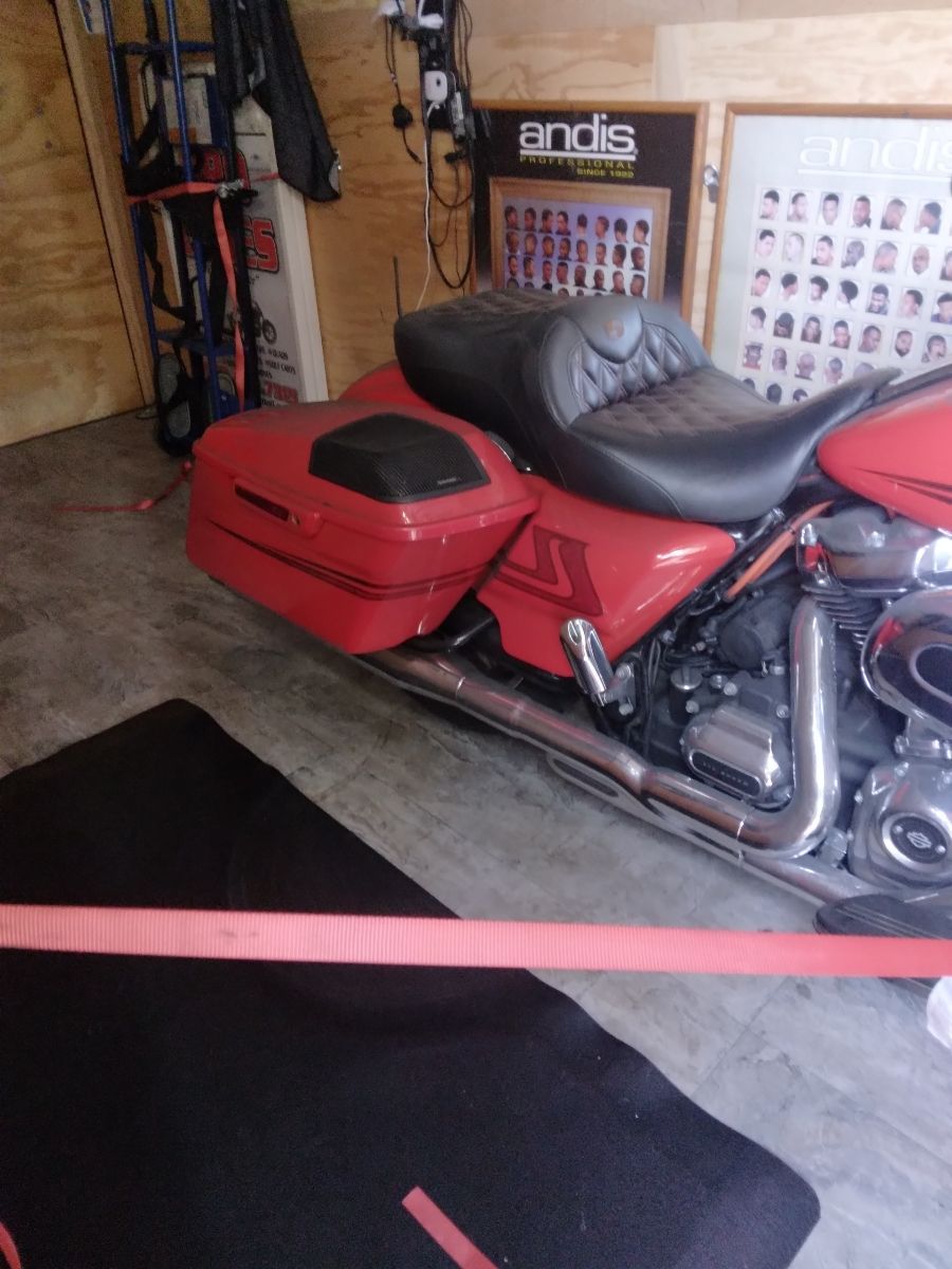 A red harley davidson motorcycle is parked in a garage