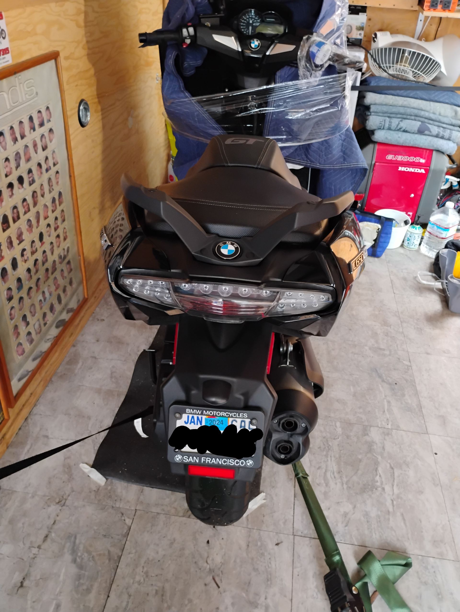 A motorcycle is sitting on the floor in a garage.