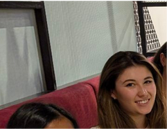 Three women are posing for a picture and smiling for the camera