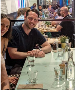 A man and a woman are sitting at a table in a restaurant