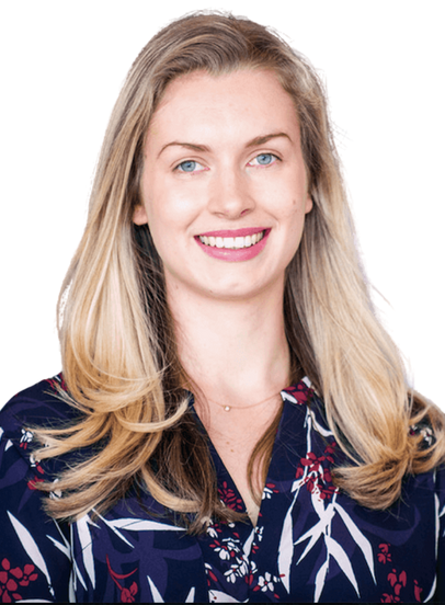 A woman wearing a scarf around her neck looks at the camera