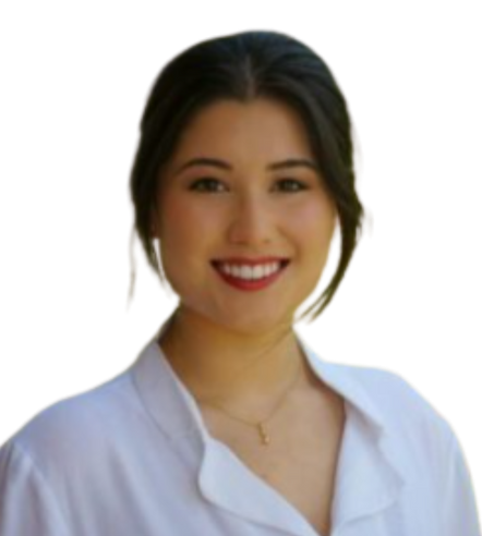 A woman in a white shirt is smiling and wearing a necklace.