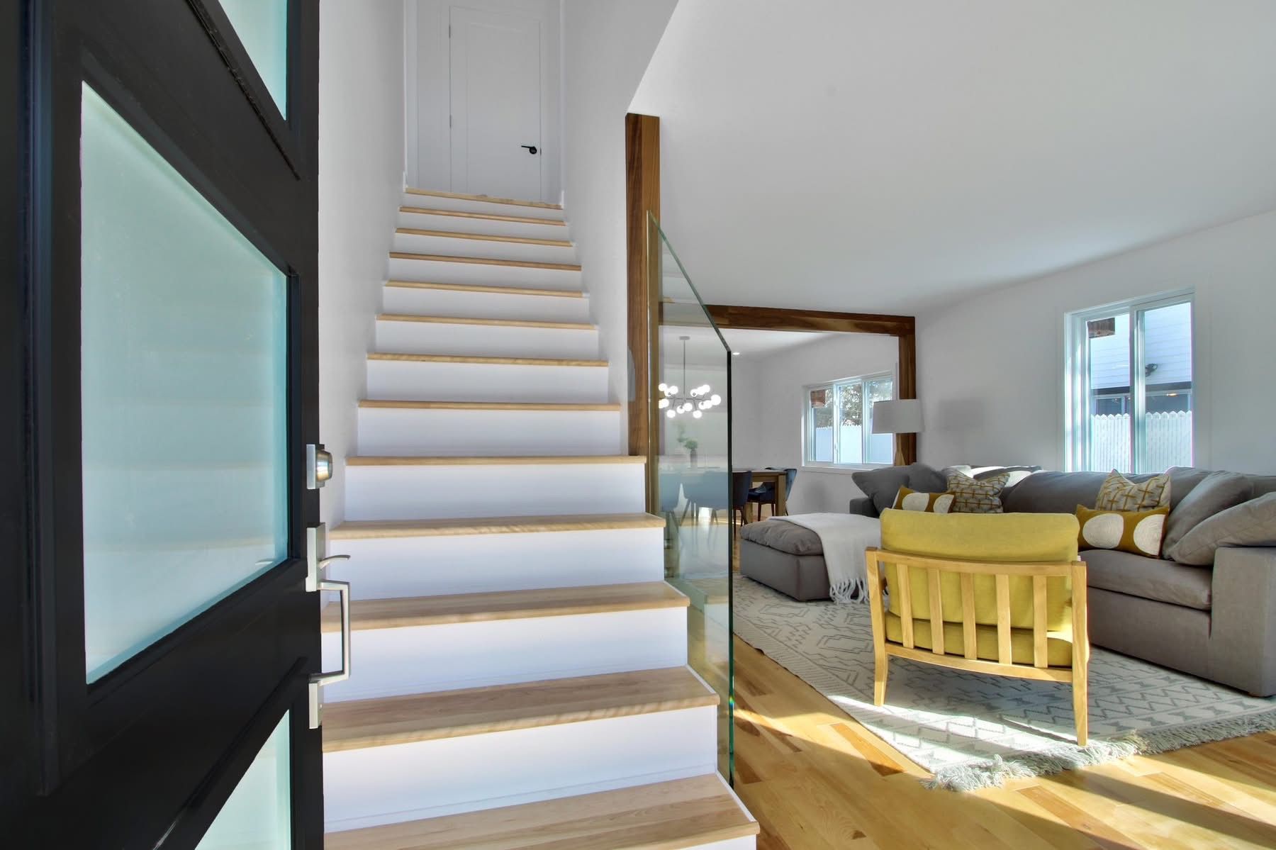 Un escalier menant à un salon dans une maison.