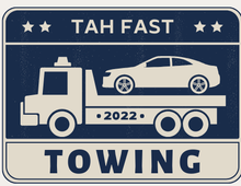 A towing truck with a car on the back of it.