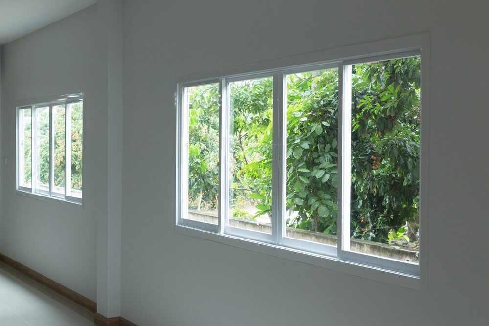 White Room With Two Sets of Windows Overlooking Green Trees and Daylight Outdoors — ACG Windows & Glass in Cheltenham, VIC