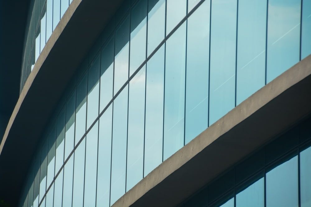 A Low-angle View of a Modern Building With a Glass Facade — ACG Windows & Glass in Lyndhurst, VIC