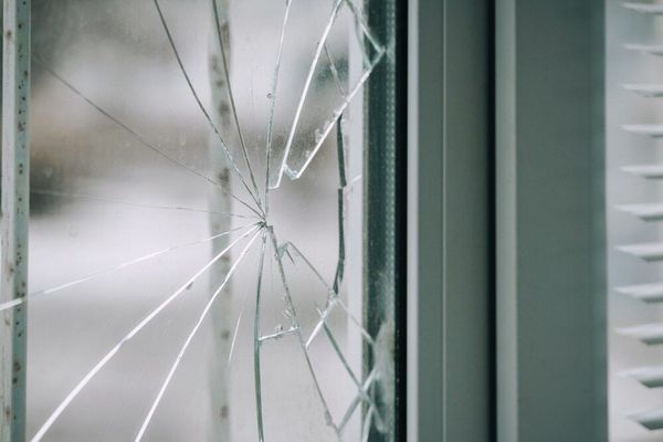 A Broken Window Pane With a Radiating Pattern of Cracks — ACG Windows & Glass in Lyndhurst, VIC