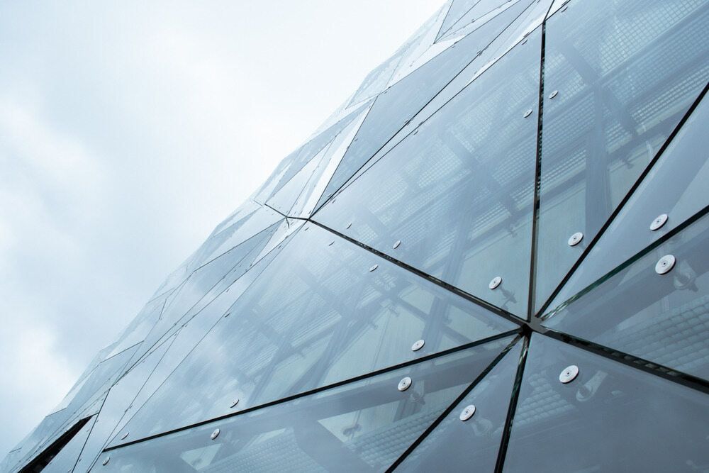 A Low-angle View of a Modern Building Facade Featuring Triangular Glass — ACG Windows & Glass in Cranbourne, VIC