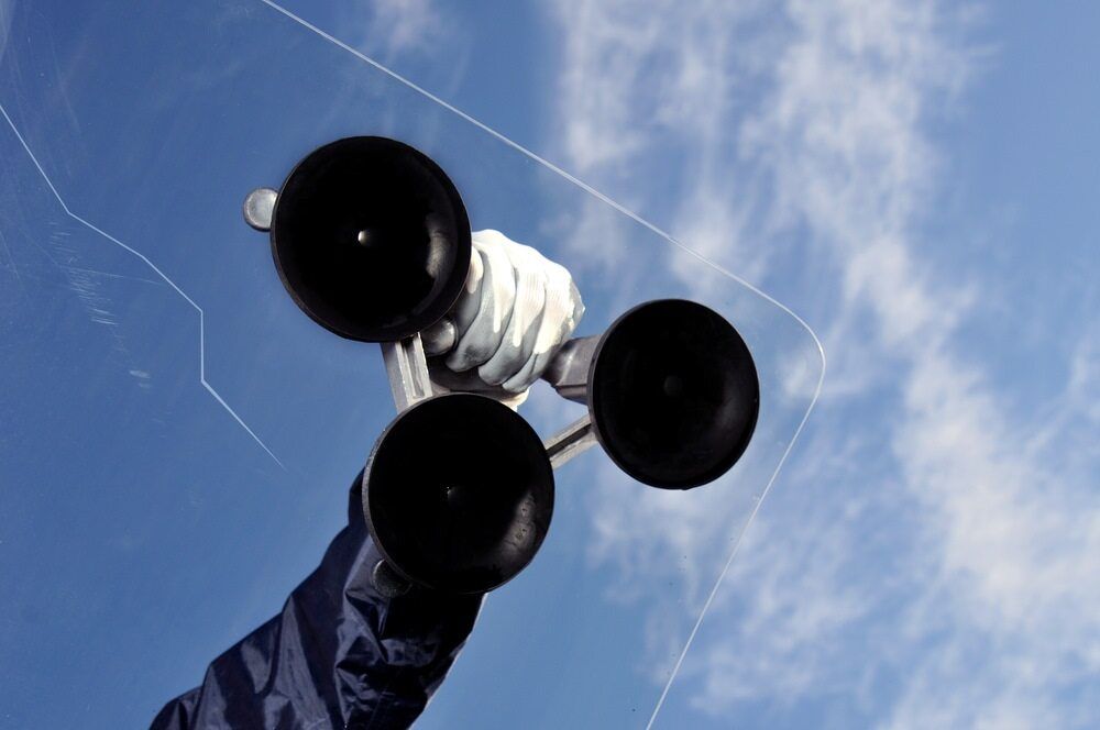 A Hand in a White Glove Holds a Triple-suction Cup Tool — ACG Windows & Glass in Seaford, VIC