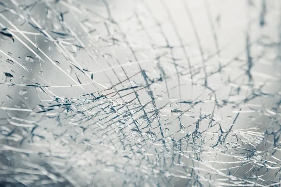 A Close-up View of a Shattered Glass Surface With Thin, Branching Cracks — ACG Windows & Glass in Lyndhurst, VIC