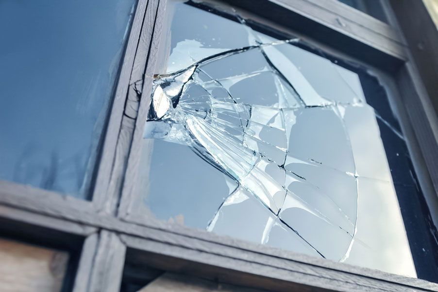Broken window pane with shattered glass in a building frame — ACG Windows & Glass in Lyndhurst, VIC