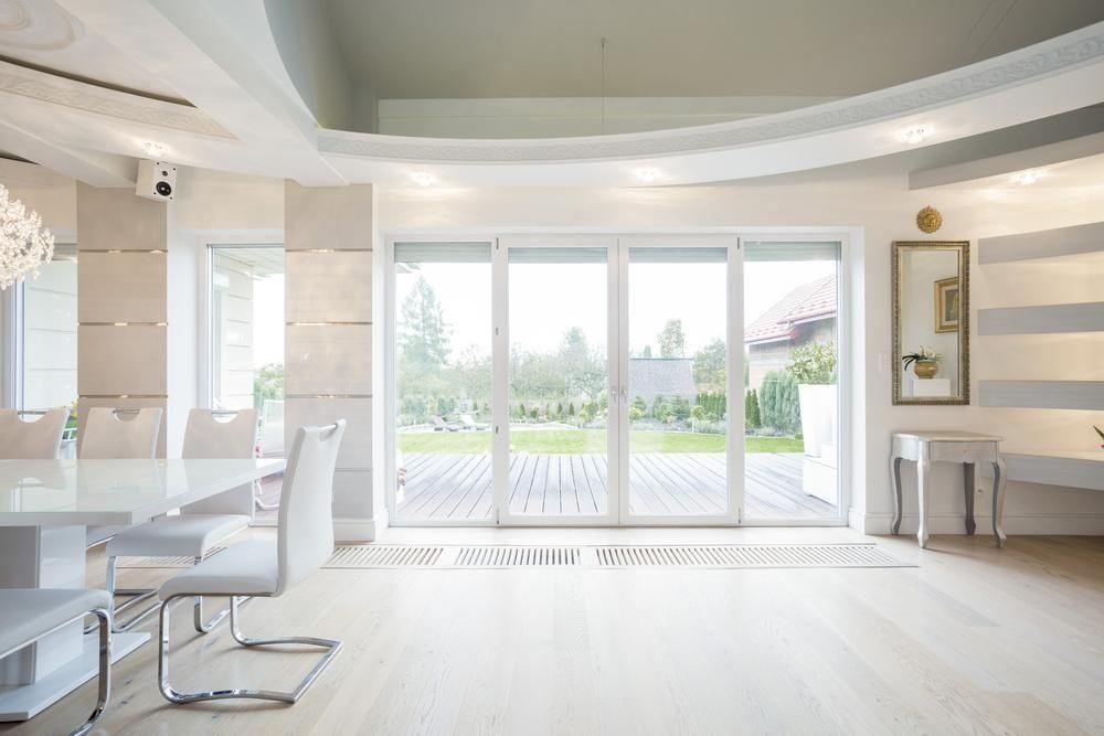A Bright, Modern Dining Room With a White Table — ACG Windows & Glass in Officer, VIC