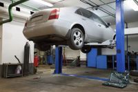 Auto Repair — Car on Lift in Auto Mechanic Shop in West Springfield, PA