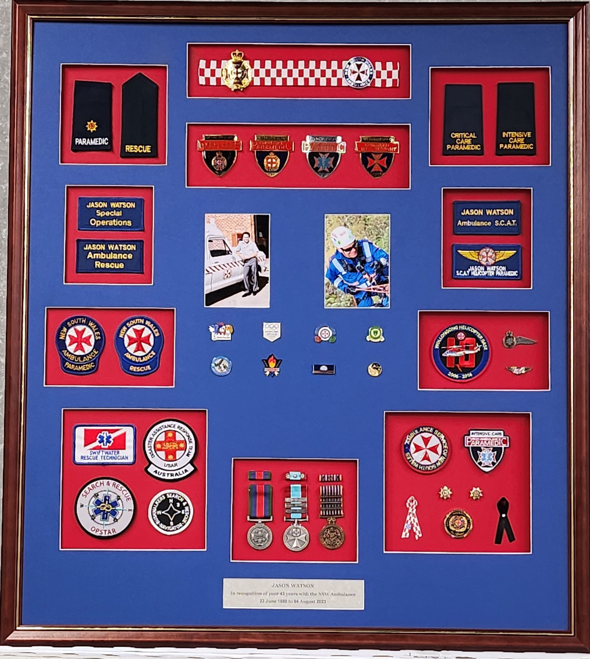 A framed display of badges and medals including one that says air