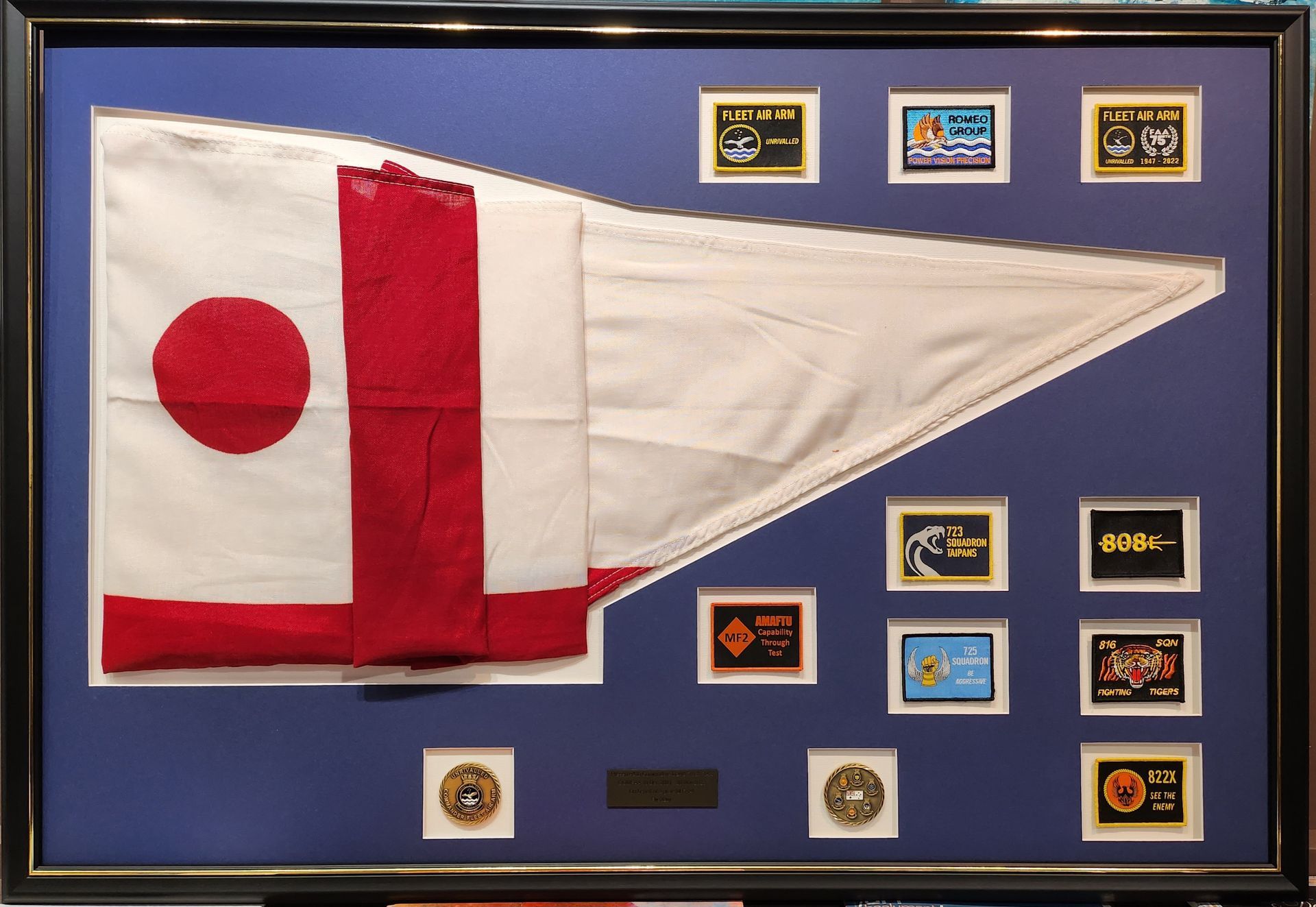 A framed flag with a red circle on it