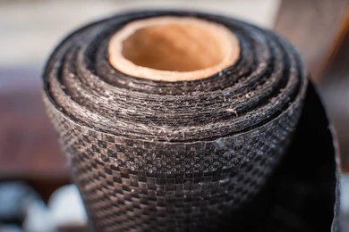 An open, black, plastic compost bin within a dug hole, surrounded by buckets of soil and grass, outdoors and root barriers — Tree Arrangements in Stratford, QLD