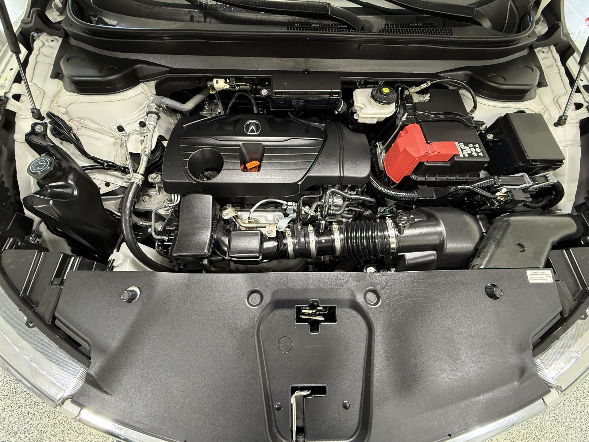 Interior of a black truck; seats, console, dashboard, and floor mat.