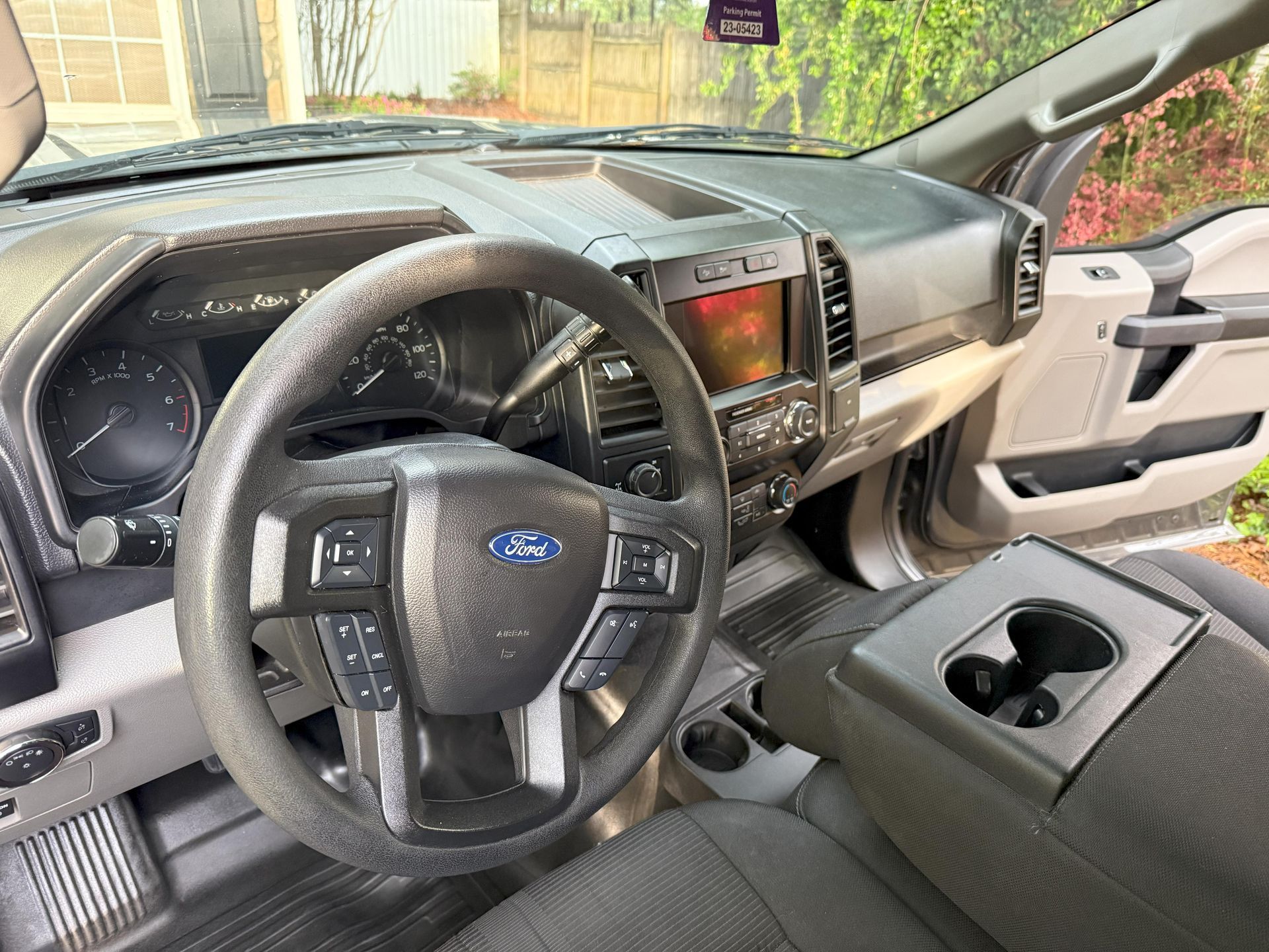 The interior of a ford truck with a steering wheel and dashboard.