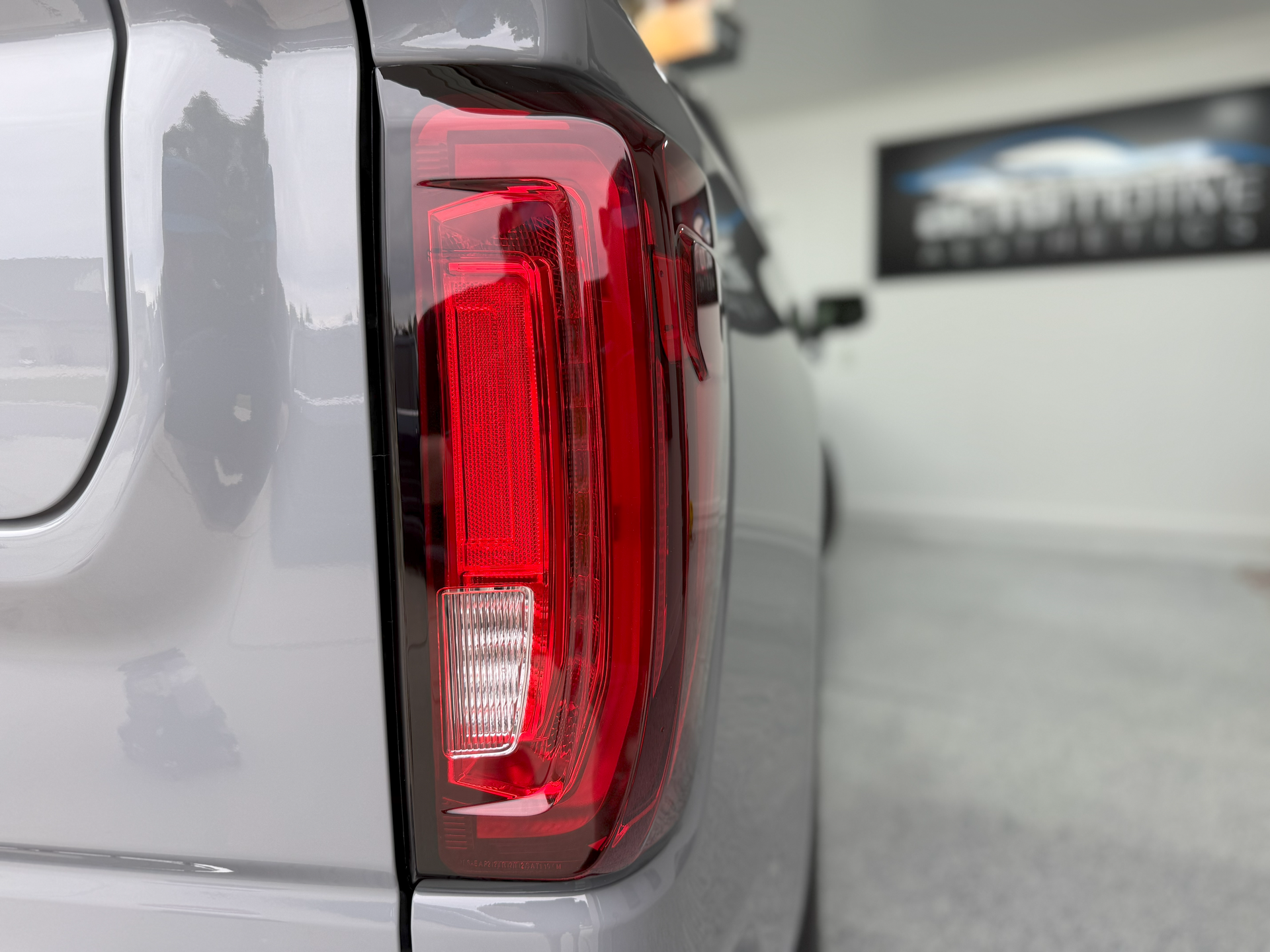 A close up of a truck 's tail light in a garage.