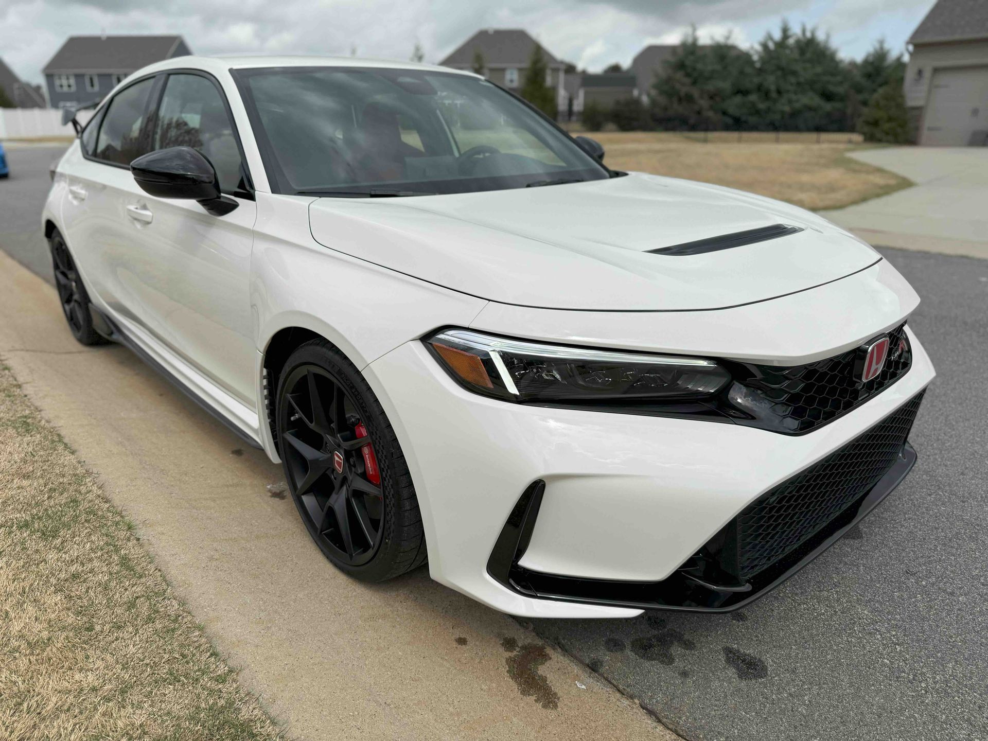 A black ford expedition is parked on the side of the road.