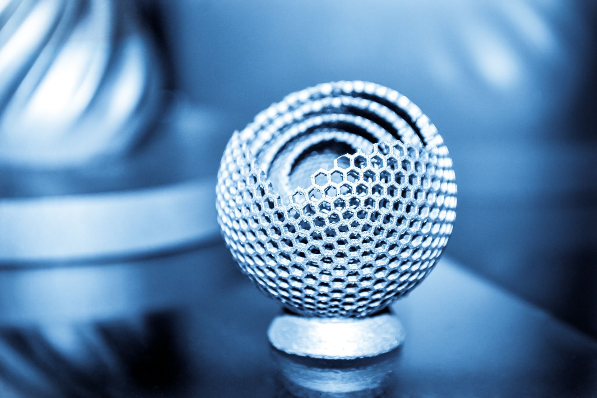 A close up of a microphone on a table with a blue background.