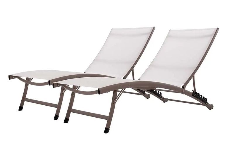 Two white lounge chairs are sitting next to each other on a white background.