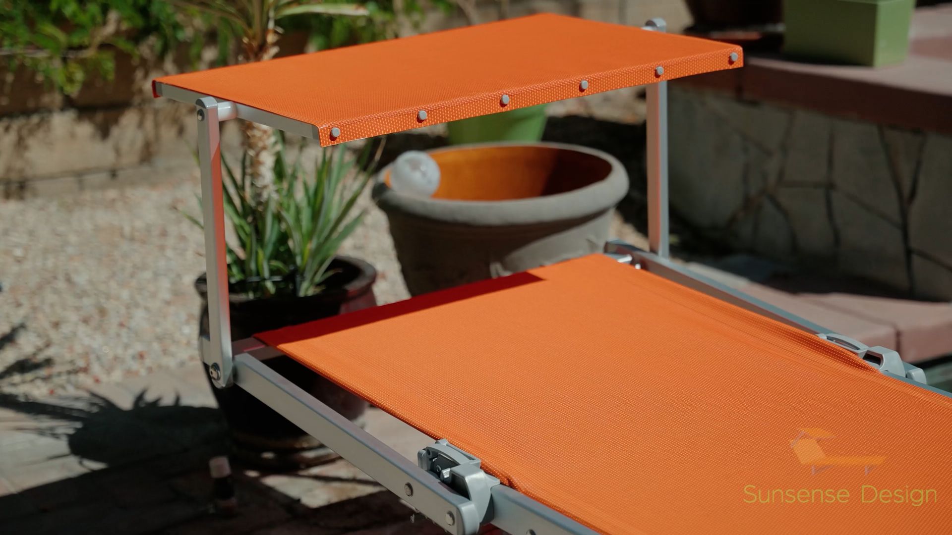 A orange chaise lounge showing it laying flat