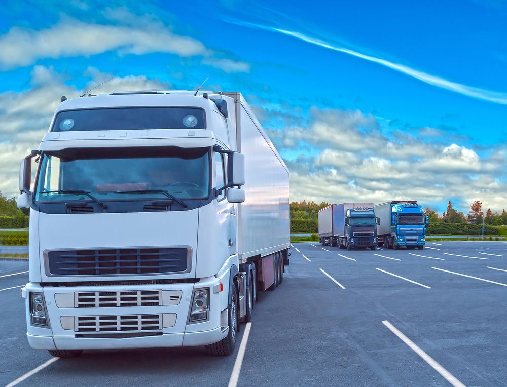White Semi-truck Parked in a Lot, With Two Other Trucks  — Hines Logistic Pty Ltd In Sydney, NSW
