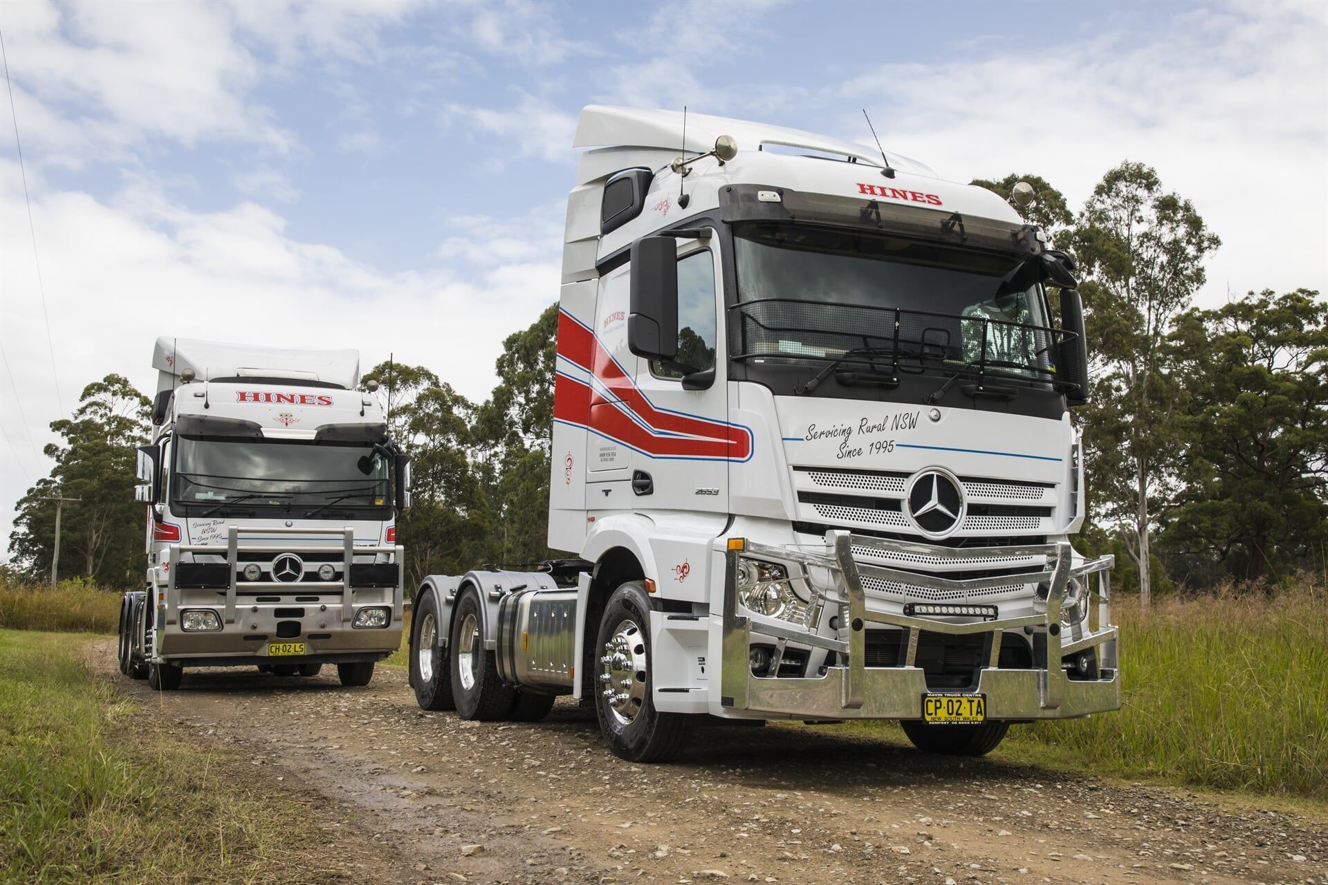 Two White Mercedes-benz Trucks on a Dirt Road — Hines Logistic Pty Ltd In Kundabung, NSW