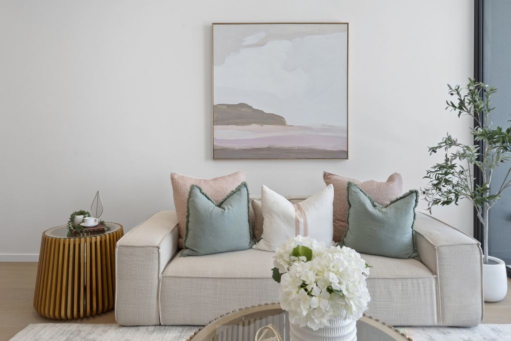 There is a painting on the wall above the couch in the living room.