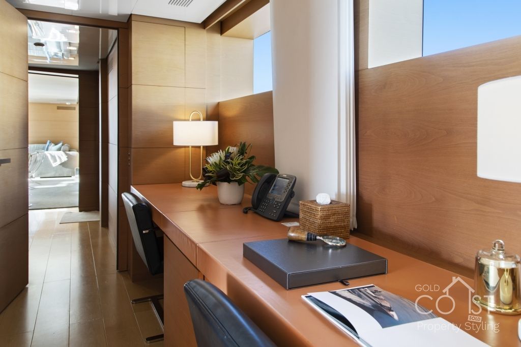 A desk with a book and a phone on it