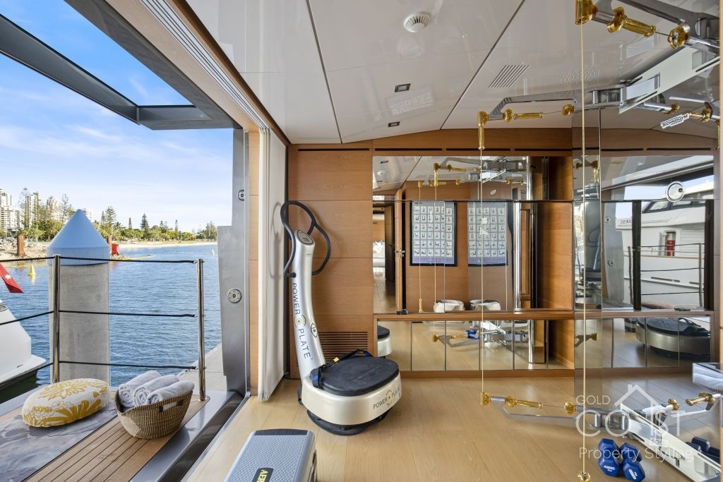 A gym on a boat with a view of the water.