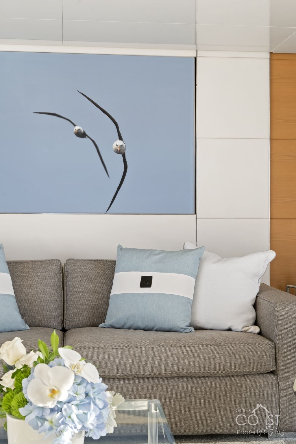 A living room with a couch and a painting on the wall